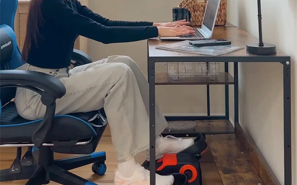 a young women is using Tousains mini elliptical machine while working at home